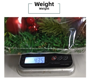 Detailed view of Christmas berry wreath weight measurement on a kitchen digital scale