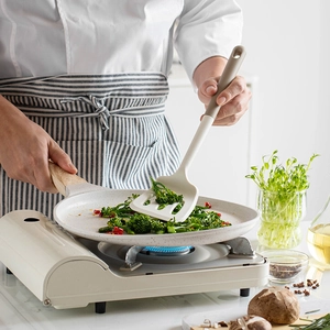 Silicone spatula and non-stick pan in a modern kitchen setting for daily home cooking