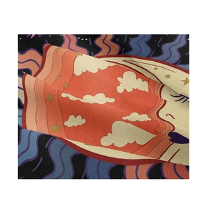 Detailed view of the fabric texture with stylized clouds, stars and wave patterns
