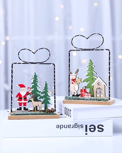 Close-up of heart-shaped Christmas lanterns with wooden base and LED lights on books