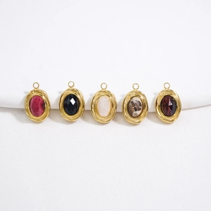 Detail of five multi-colored oval natural stone pendants with gold metal edge trim