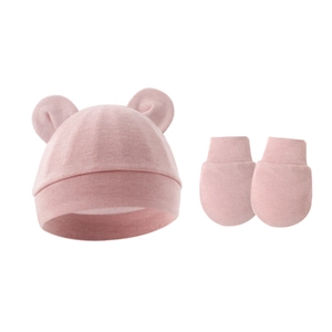 Detail of pink knitted newborn set with 3D bear ears hat and anti-scratch mittens