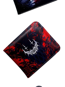 Macro detail of bifold wallet featuring vintage skull print and artistic red splatter design