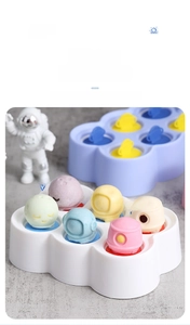 Detail of space-themed silicone ice cream molds with moon, astronaut and rocket shapes
