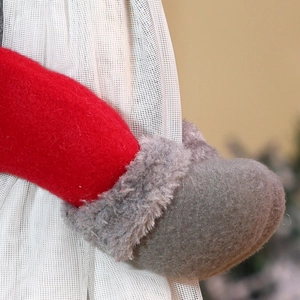Close-up of plush red felt and grey faux fur detail on a festive Christmas curtain tieback