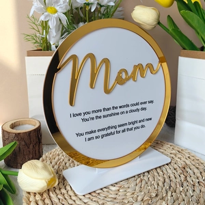 Detail of round acrylic Mother's Day plaque with gold 'Mom' script and heartfelt poem