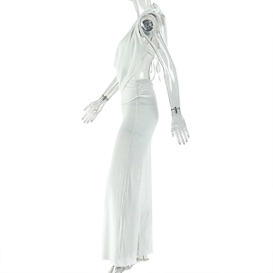 Detail view of white halter neck top and high-waisted wide leg trousers on a model