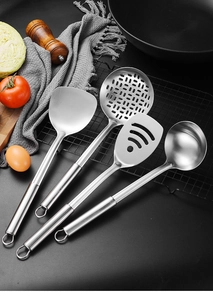 Detailed view of 4-piece stainless steel utensil set with hanging loops on black background