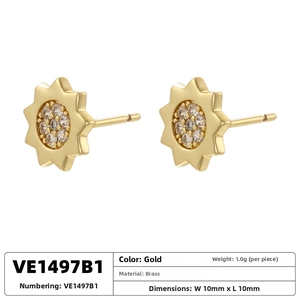 Macro shot of gold floral stud earrings with white zircon on a clean white background