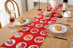 Detail of red table runner with traditional fish and lantern illustrations for Christmas