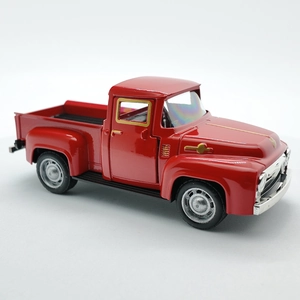 Close-up of red vintage alloy pickup truck toy with metallic finish on white background
