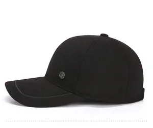 Side view of black baseball cap with fine twill texture and circular metal badge detail