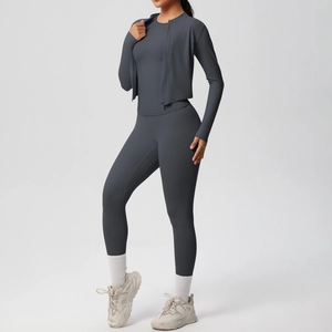 Detail view of a three-piece yoga set with a slim-fit jacket and high-waist leggings