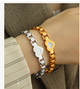Detail of heart bracelet with mother of pearl inlay and Roman numeral engraving