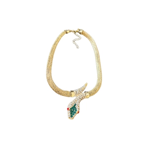 Golden snake-shaped necklace set with green and white rhinestones on white background