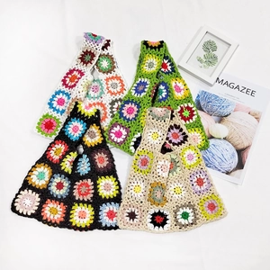 Close-up of handmade crochet tote bag featuring colorful sunflower granny square patterns
