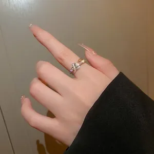 Double-layered zirconia letter open ring with gold and silver intertwining finish