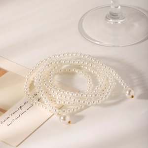 Elegant multi-layer white pearl necklace with gold clasp in a stylish spiral arrangement
