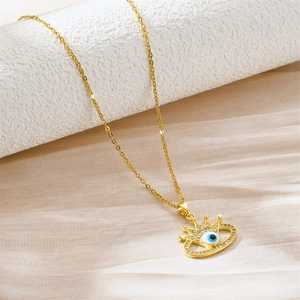 Detail of gold crown evil eye pendant with micro-paved crystals on an O-chain