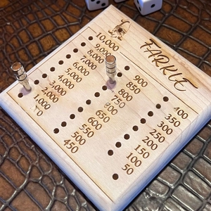 Close-up of wooden Farkle dice tray with clear scoring scales and metal tracking pegs