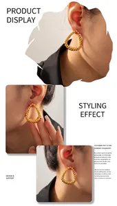 Model display of large golden twisted hoop earrings with textured metallic finish