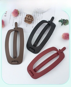 Matte oval hair clips in brown, black, and burgundy with a minimalist frosted finish