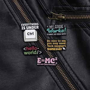 Macro shot of 5 funny programmer enamel pins on a black leather jacket near a zipper