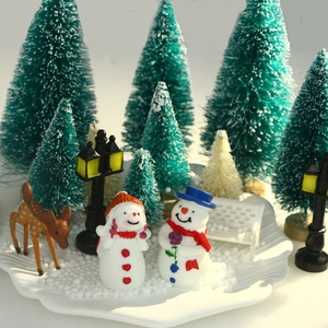 Miniature Christmas scene kit with snowmen, deer, and sisal bottle brush trees in snow