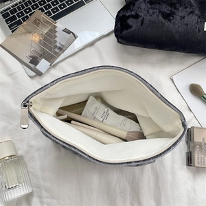 Macro view of grey velvet cosmetic bag with canvas lining and spacious interior