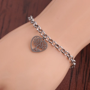 Silver stainless steel bracelet featuring a heart-shaped Tree of Life charm on wrist
