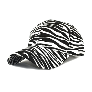 Cotton baseball cap with black and white zebra print pattern from a side-angle view