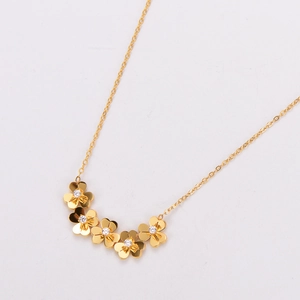 Detail of five 18K gold plated clover-shaped flowers with sparkling zircons on a necklace