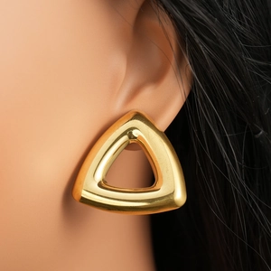 Macro view of chunky hollow gold triangle earrings with a high-polished metallic finish