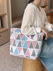 Large canvas tote bag with geometric print and white rope handles for beach and daily use