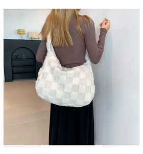 Lifestyle shot of large plush checkerboard tote bag worn on shoulder by model