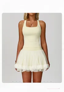 Detail of cream yoga set featuring racerback tank top and tiered mesh tutu skirt