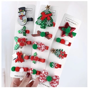 Detail of Christmas hair clips set with snowman and tree designs for young girls