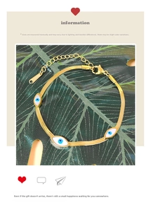 Detail of gold evil eye bracelet in stainless steel with blue enamel charms on green leaf