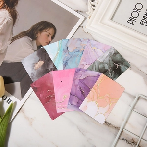 Detailed view of colorful marble patterned jewelry cards featuring elegant gold foil accents.