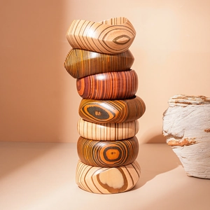 Set of 7 handmade geometric wooden bangles with natural grain in various earthy tones