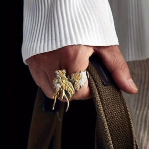 Close-up of a vintage dragon ring in gold and silver finish showing detailed scales