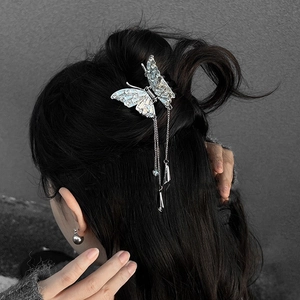 Silver butterfly hair claw clip with crystal tassel charms on model with black hair