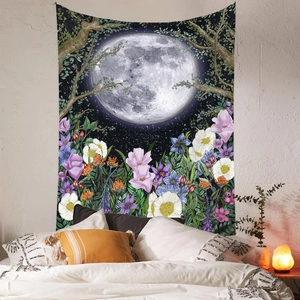 Moon phase tapestry with stars and flowers hanging on a bedroom wall above the bed