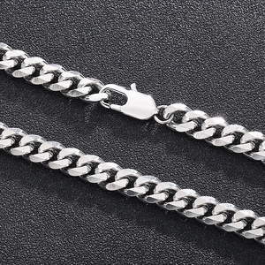 Silver stainless steel Cuban link necklace with lobster clasp shown on a dark background