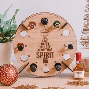 Wooden Christmas countdown wine rack with 12 personalized slots for mini bottles