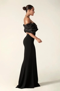 Detail of the elegant ruched off-shoulder sleeves on this black formal evening gown