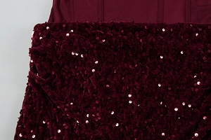 Detail of burgundy bodycon dress featuring sequin stitching and premium fabric texture