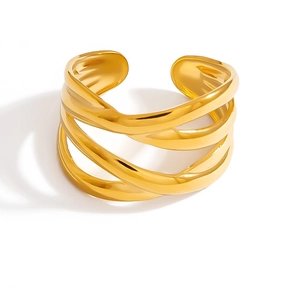 Detailed close-up of a wide golden hollow ring featuring an irregular twisted texture design