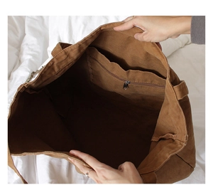 Overhead view showing spacious interior and zip pocket of this brown canvas tote bag