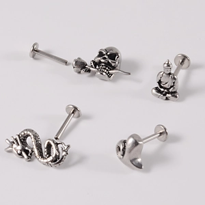 Silver stainless steel body piercing set featuring skull, buddha, and dragon studs